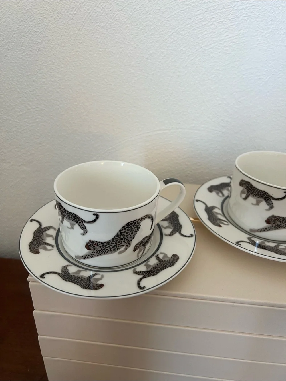 Cup and saucer set with black leopard print on white background